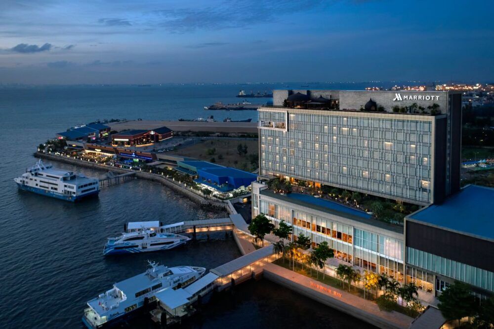 Resort pool and curved hotel architecture at dusk